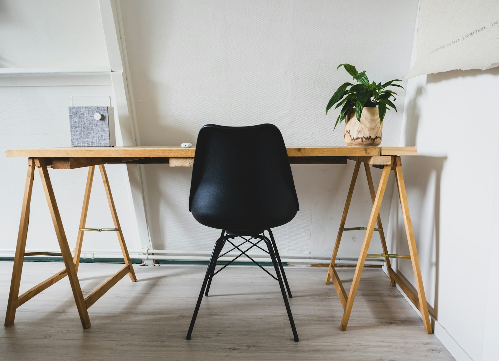 DIY small apartment desk with Eames chair plant and speaker setup