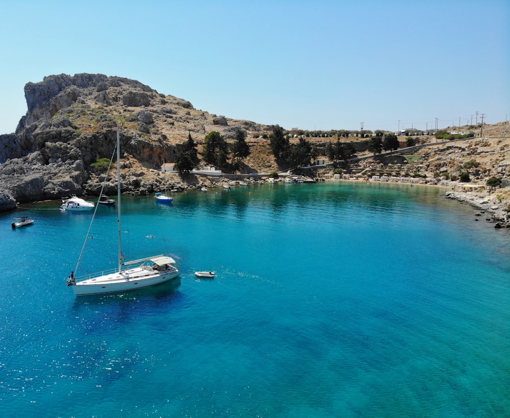 white and blue boat on water during daytime