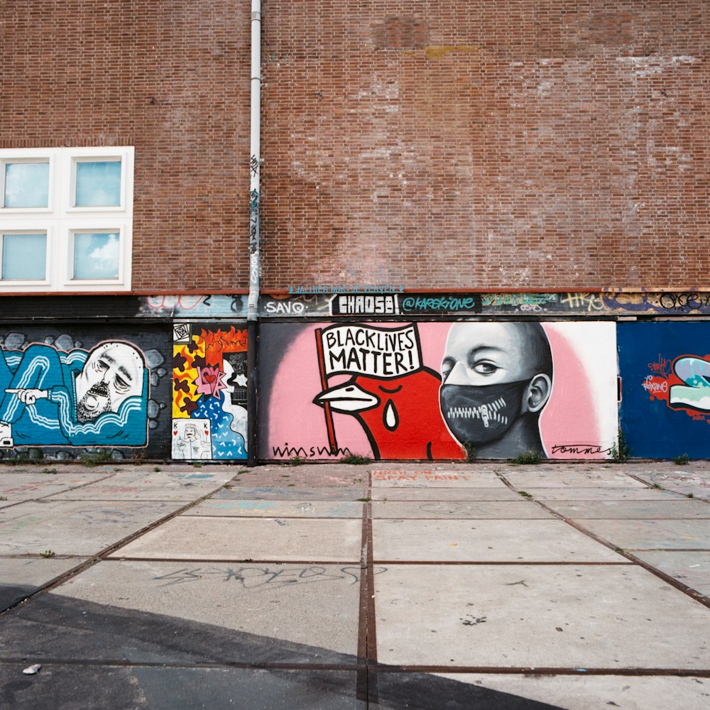 brown brick wall with graffiti