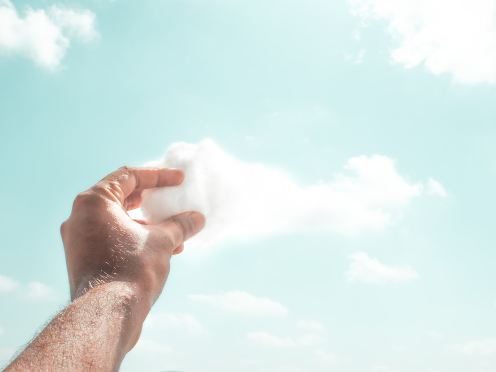 person holding white cotton candy