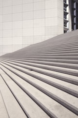 brown wooden stairs near white concrete building