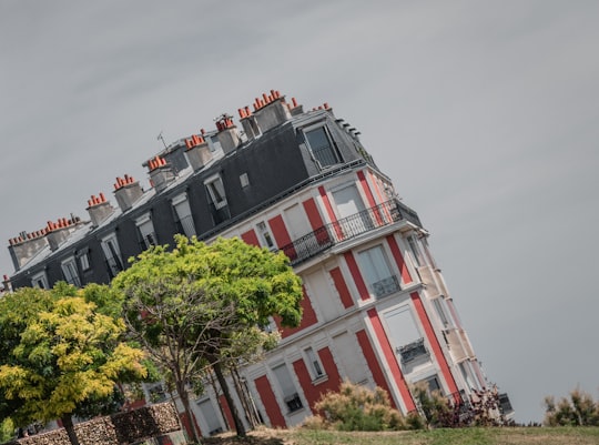 red and white concrete building in Square Louise Michel France