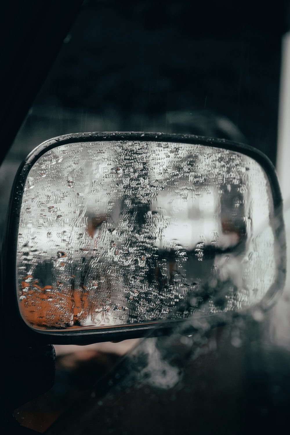 car side mirror with water droplets