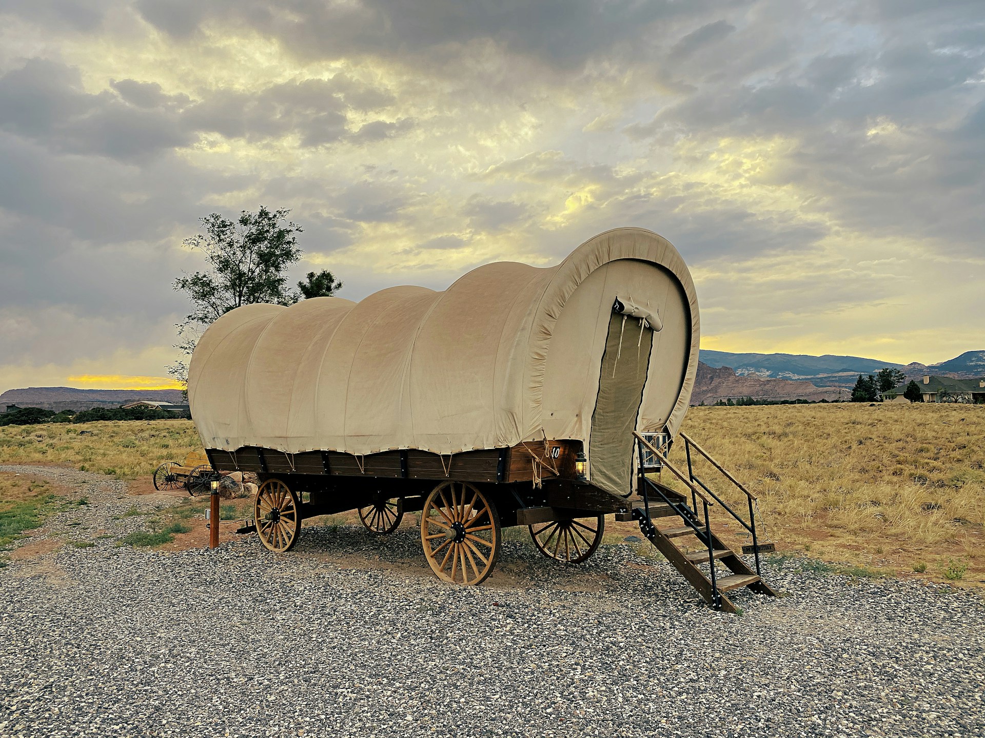 brown wooden carriage on gray sand during daytime
