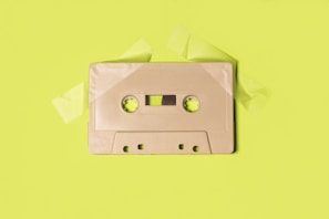 gray cassette tape on yellow surface
