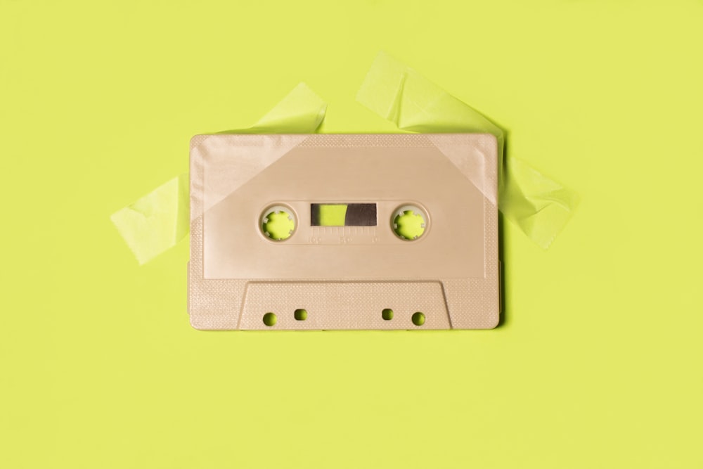 gray cassette tape on yellow surface