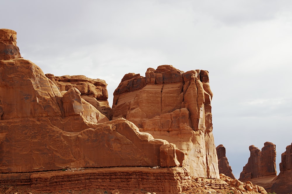 brown rock formation under white sky during daytime