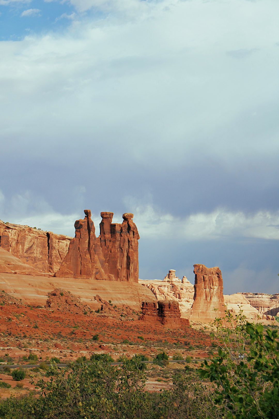 brown rock formation under white clouds during daytime
