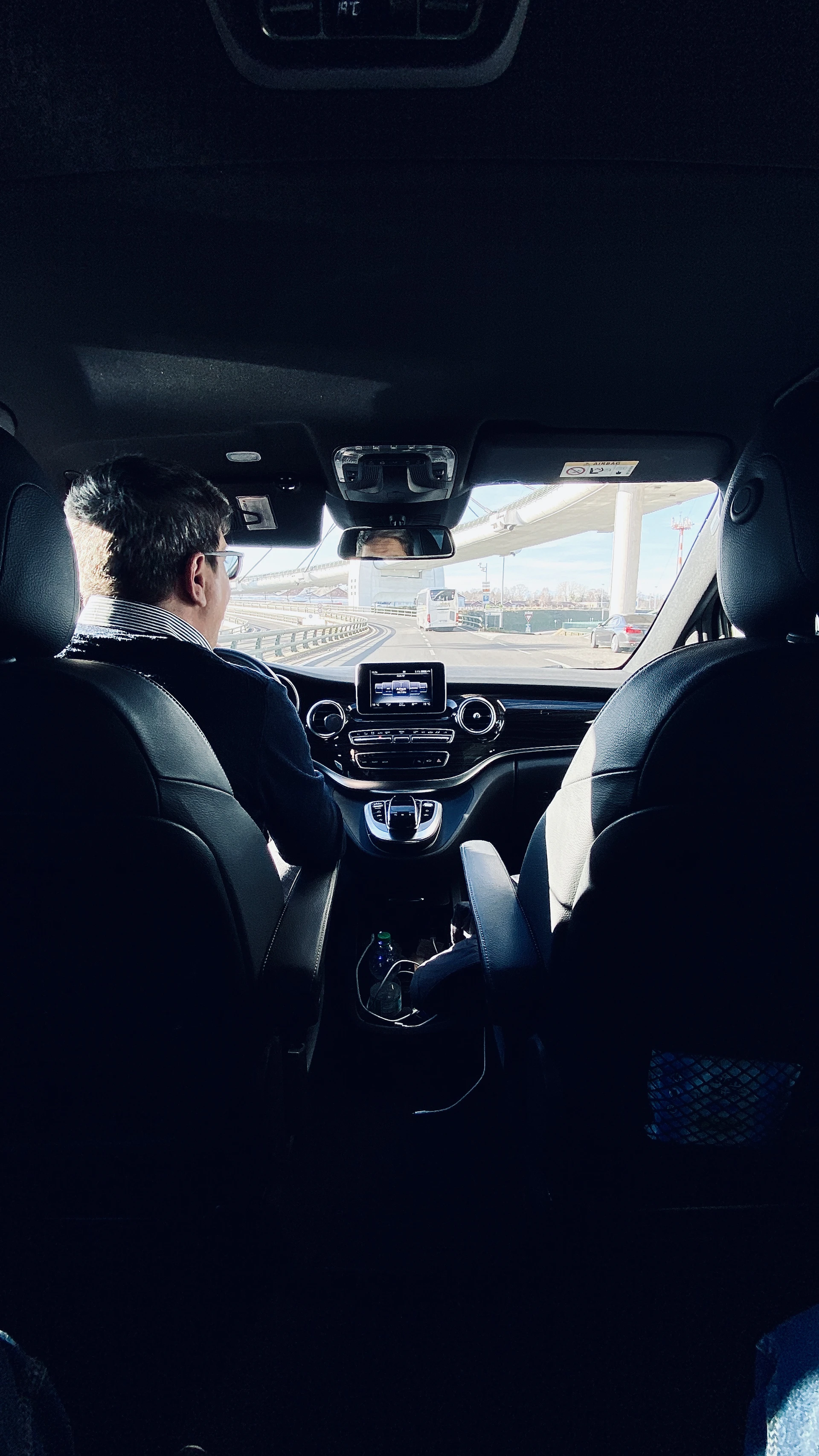 View from inside a chauffeur-driven vehicle looking out over a bridge