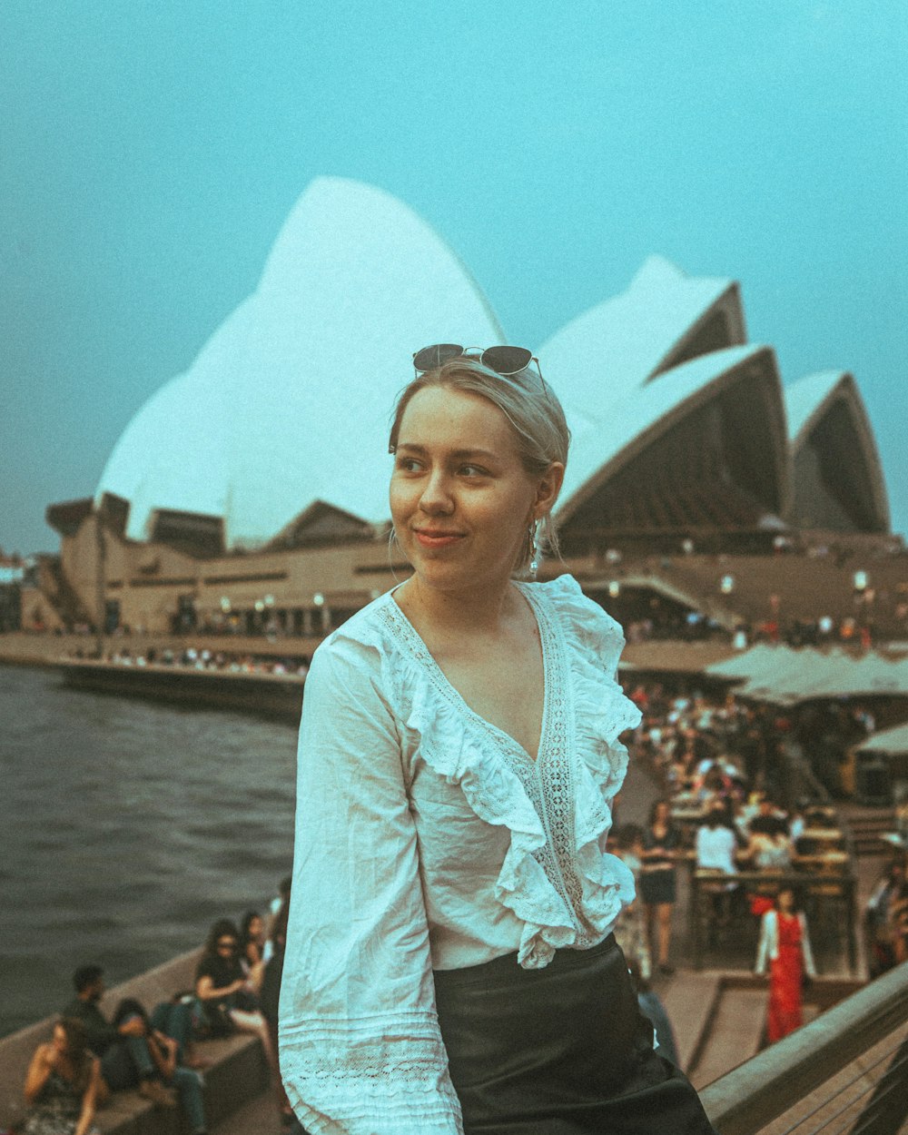 woman in white floral long sleeve shirt standing near body of water during daytime