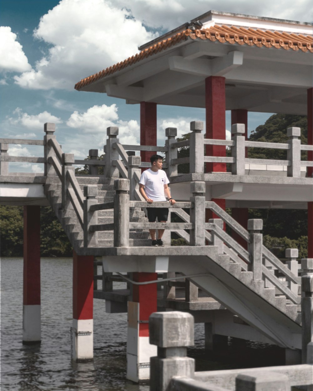 woman in white shirt sitting on brown wooden bench during daytime