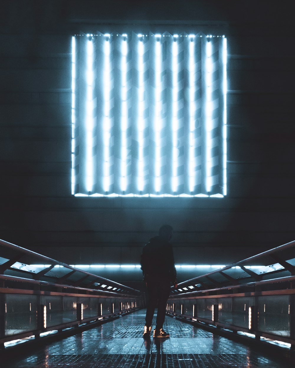 person in black jacket walking on hallway