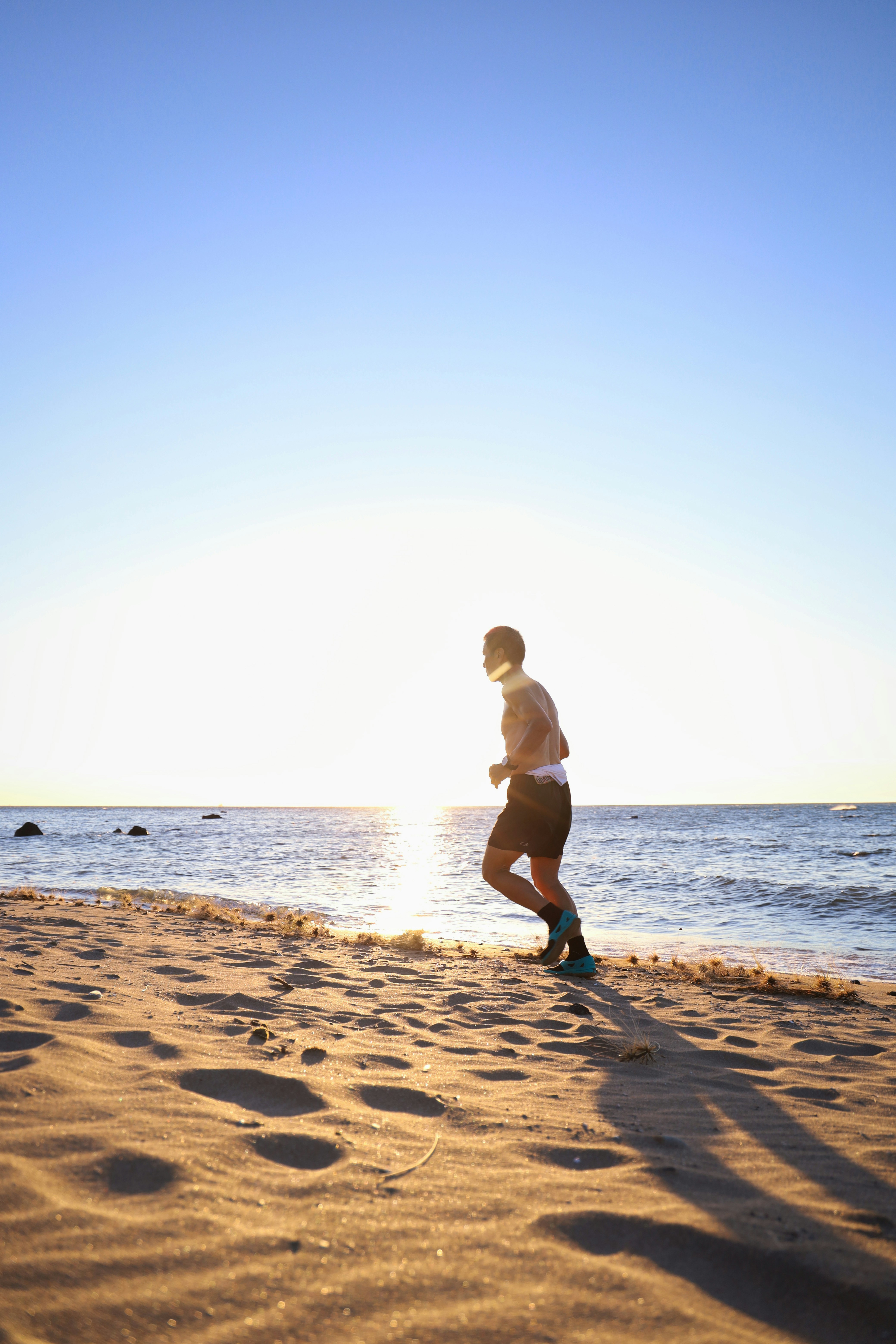 Easy Wellness Habits You Can Actually Stick To This Week – man in black shorts running on beach during daytime