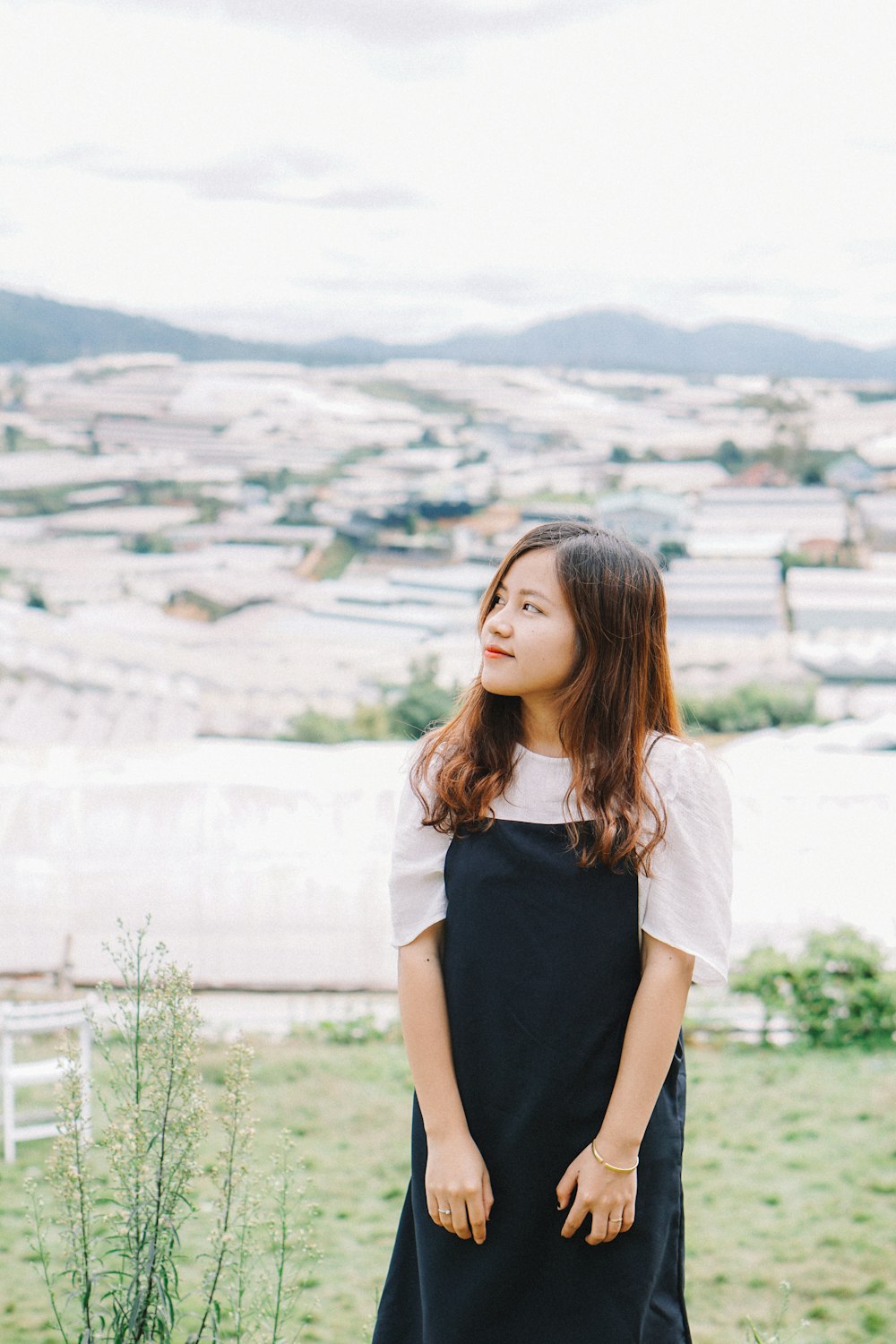 a woman standing on top of a lush green field