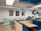 a restaurant with blue booths and wooden tables