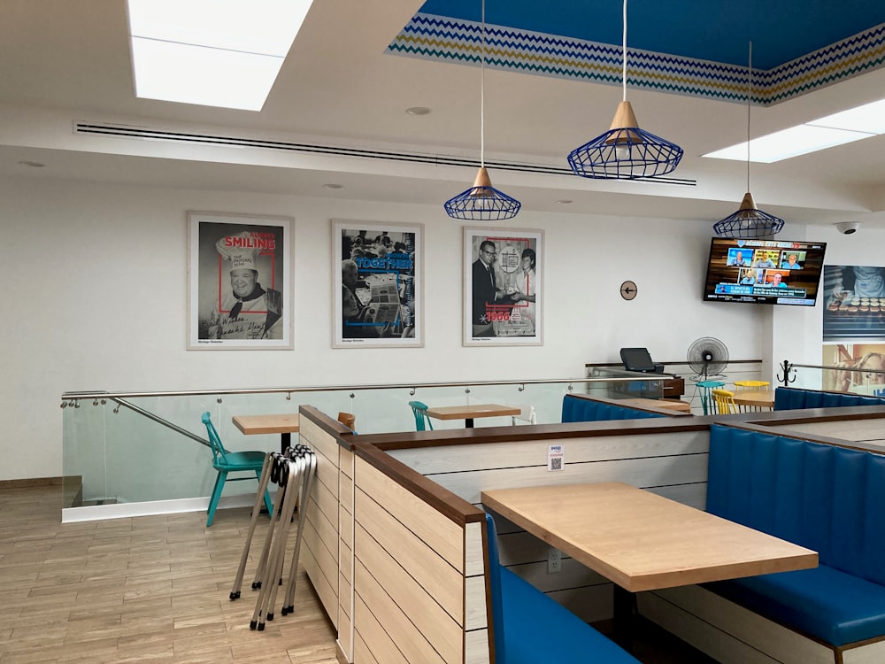 a restaurant with blue booths and wooden tables