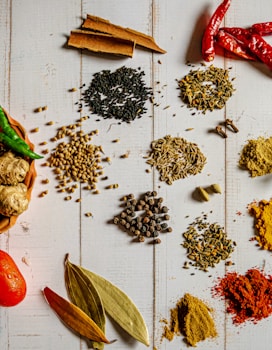 a variety of spices on a white table