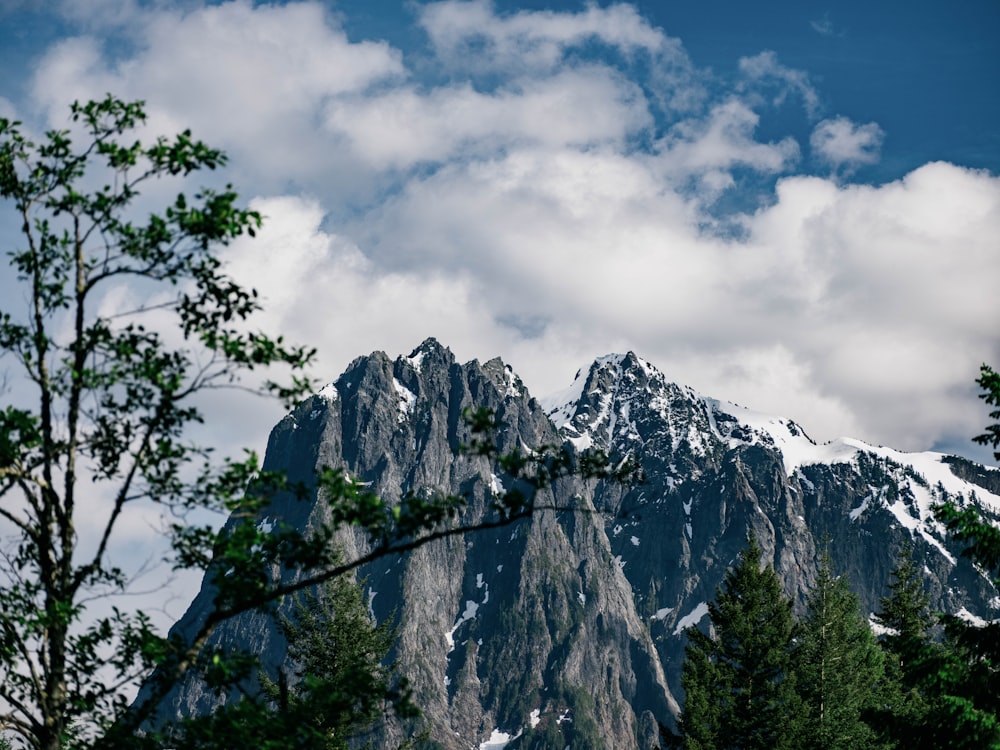 snow covered mountain under cloudy sky during daytime