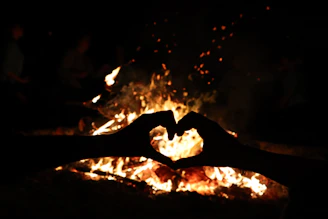 Romantic fire heart burning brightly at an outdoor wedding celebration.
