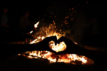 Romantic fire heart burning brightly at an outdoor wedding celebration.