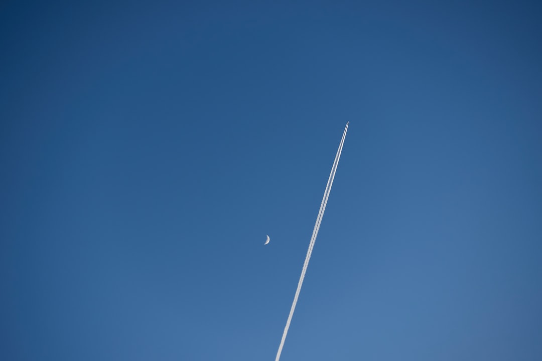 white plane in the sky during daytime