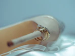 gold ring on white textile
