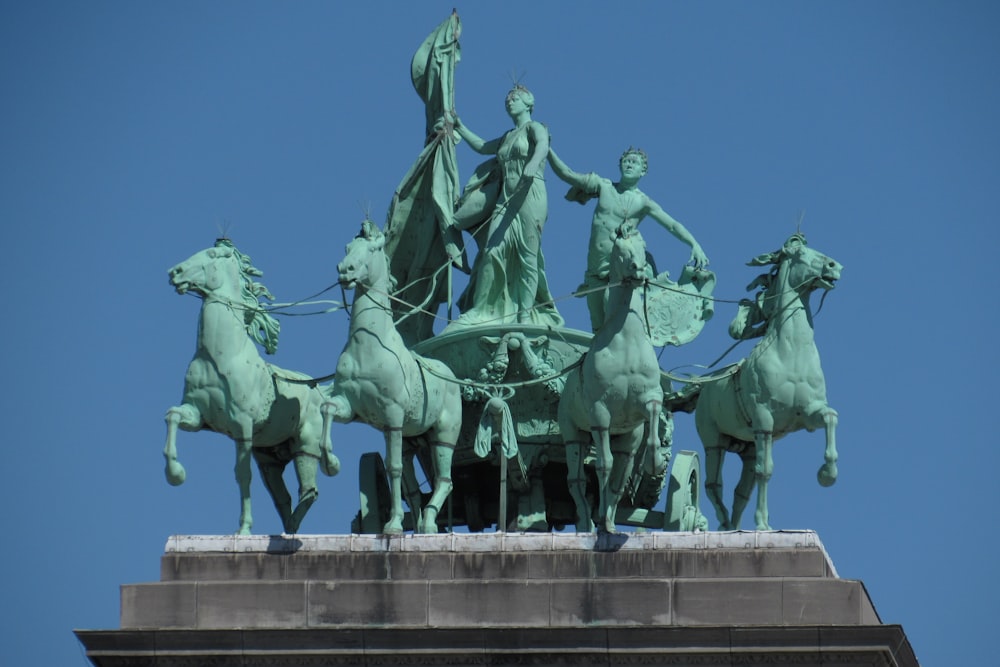 people riding horse statue during daytime