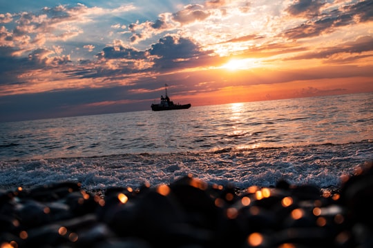 silhouette of boat on sea during sunset in Batumi Georgia