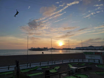 Sunset casting golden light on adventurers preparing for their next zipline ride.