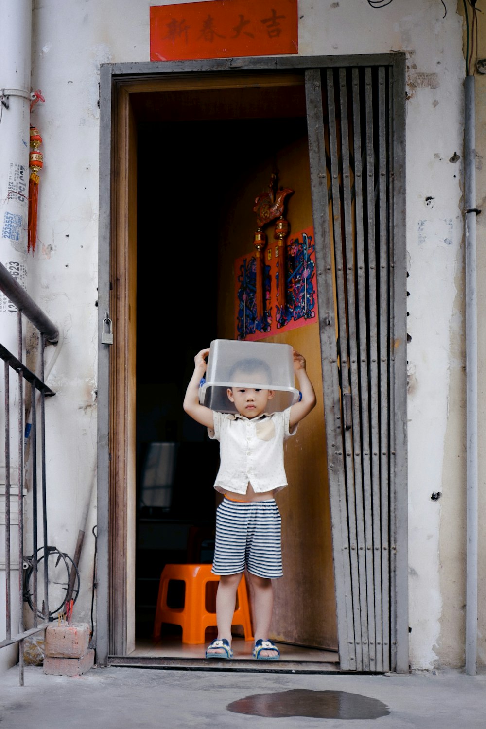 woman in white dress and white hat standing on orange plastic chair