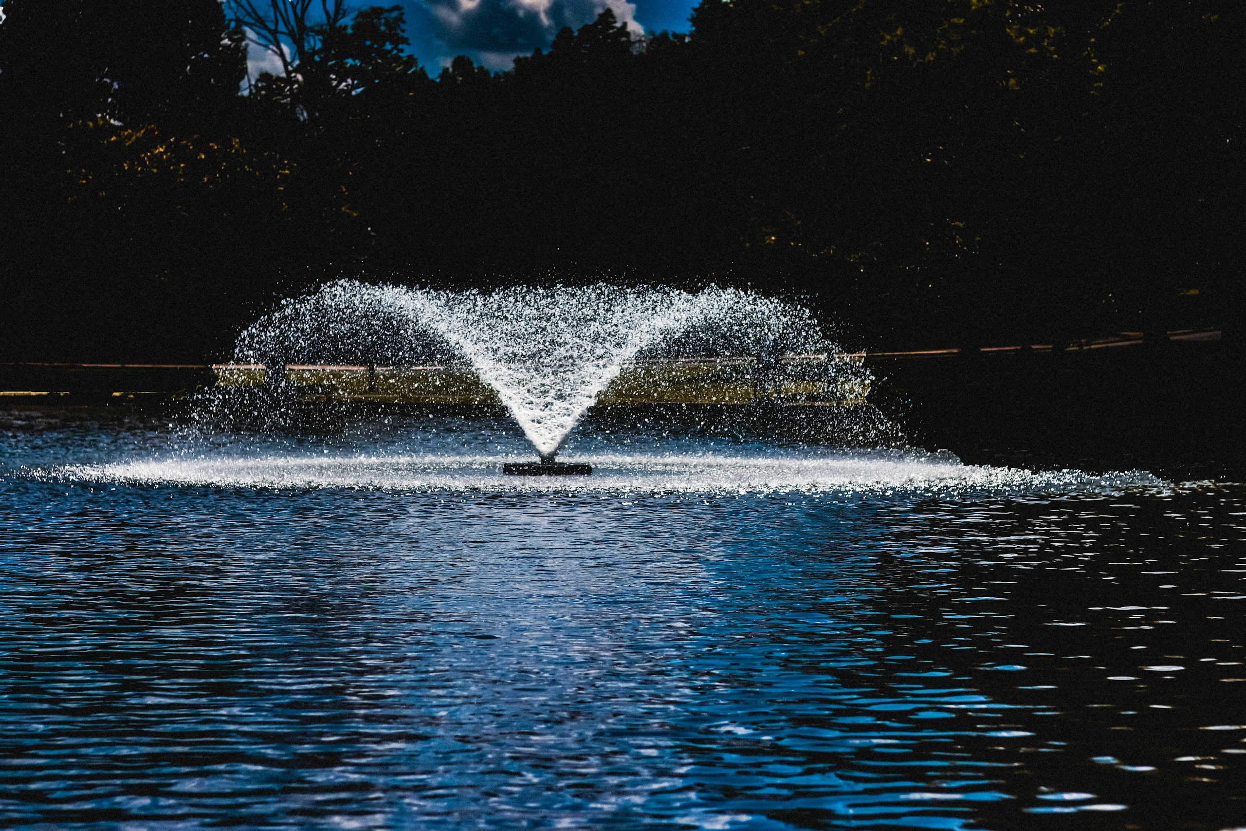 fountain in the middle of the lake during night time