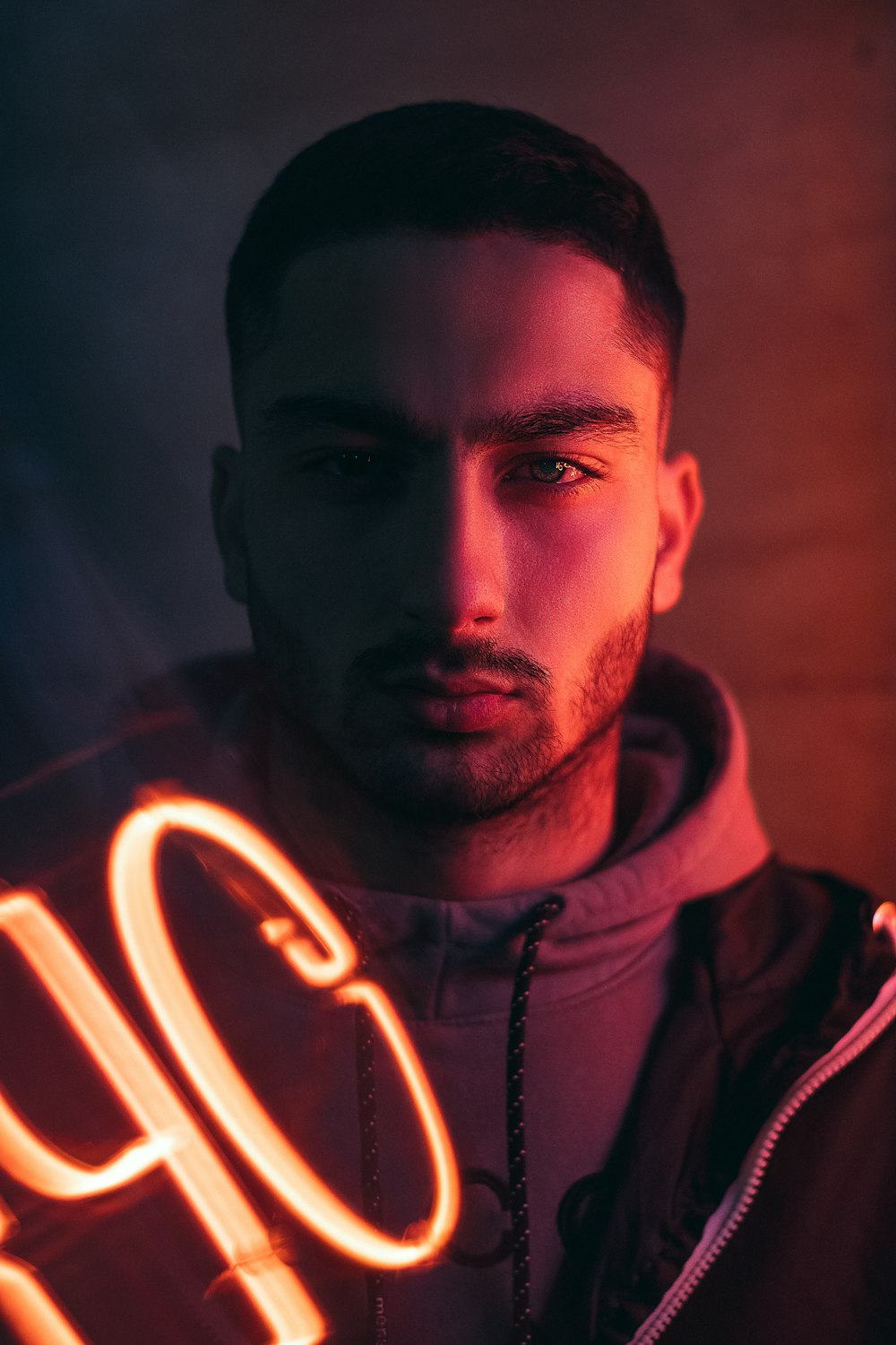 man in black hoodie with white light in his face