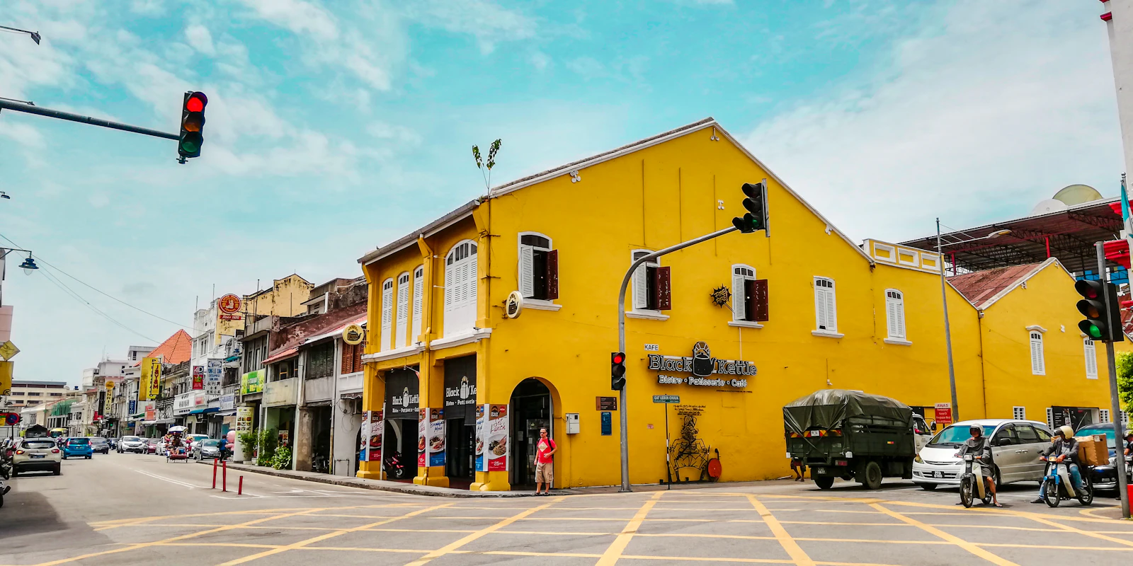 A yellow heritage building at a Penang street junction