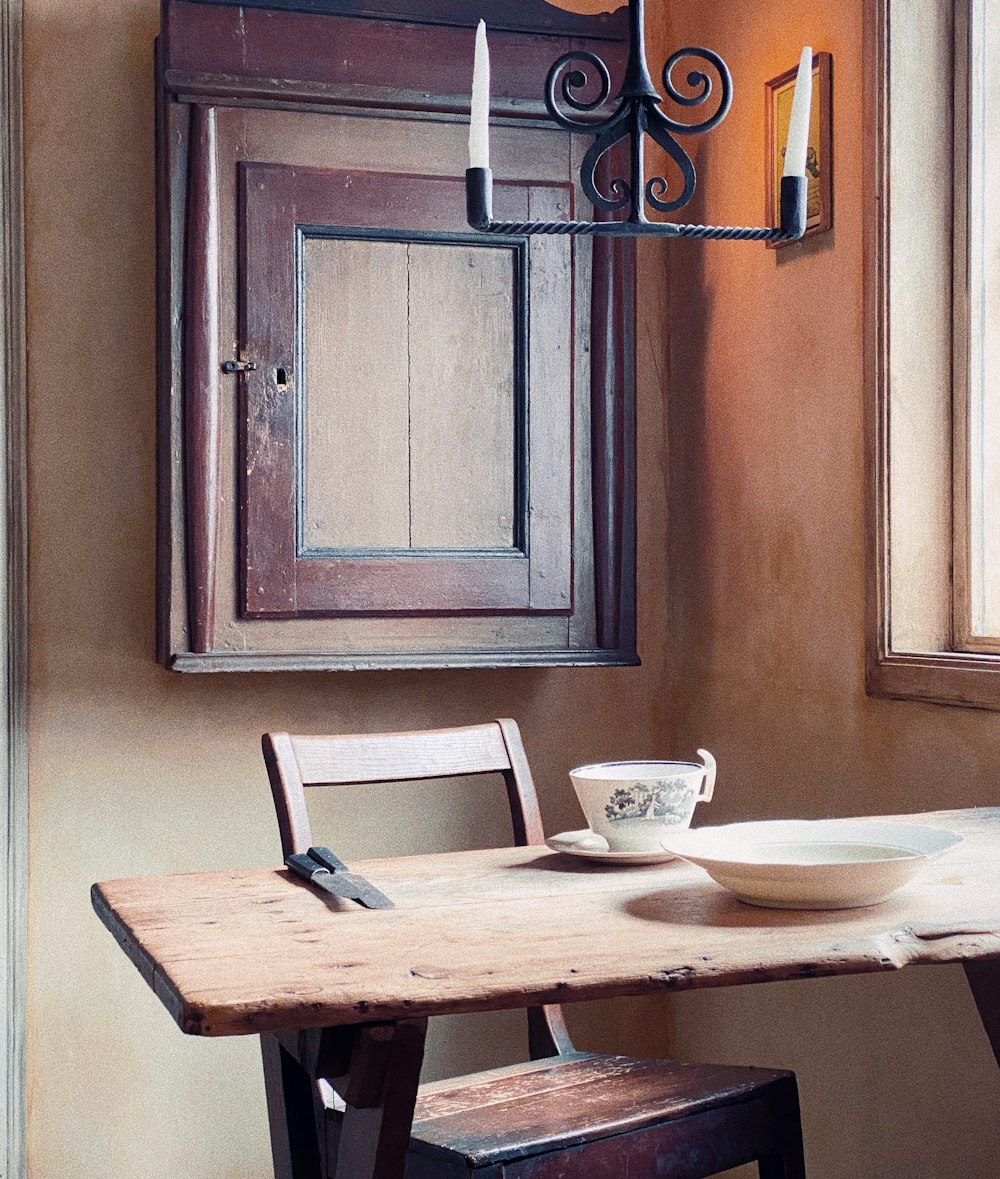 white ceramic teacup on brown wooden table