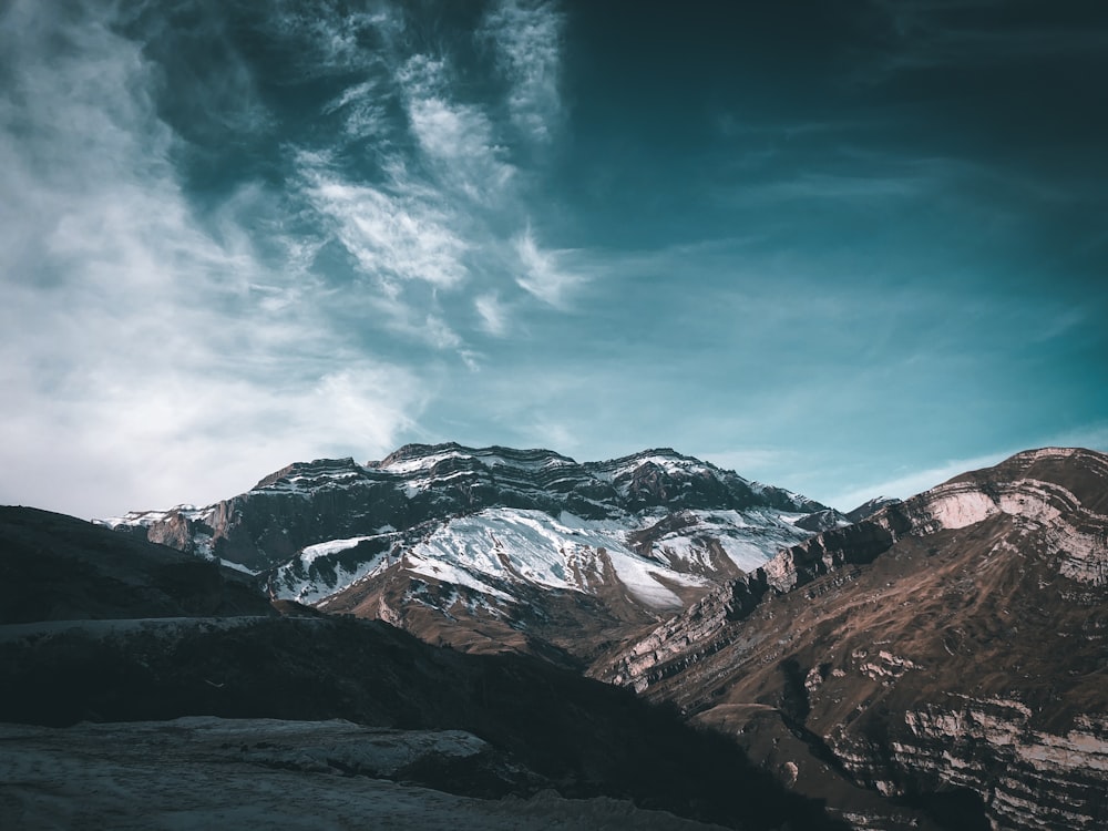 snow covered mountains under blue sky during daytime