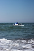A jetski skimming over clear blue water near Browns Bay on a sunny day.