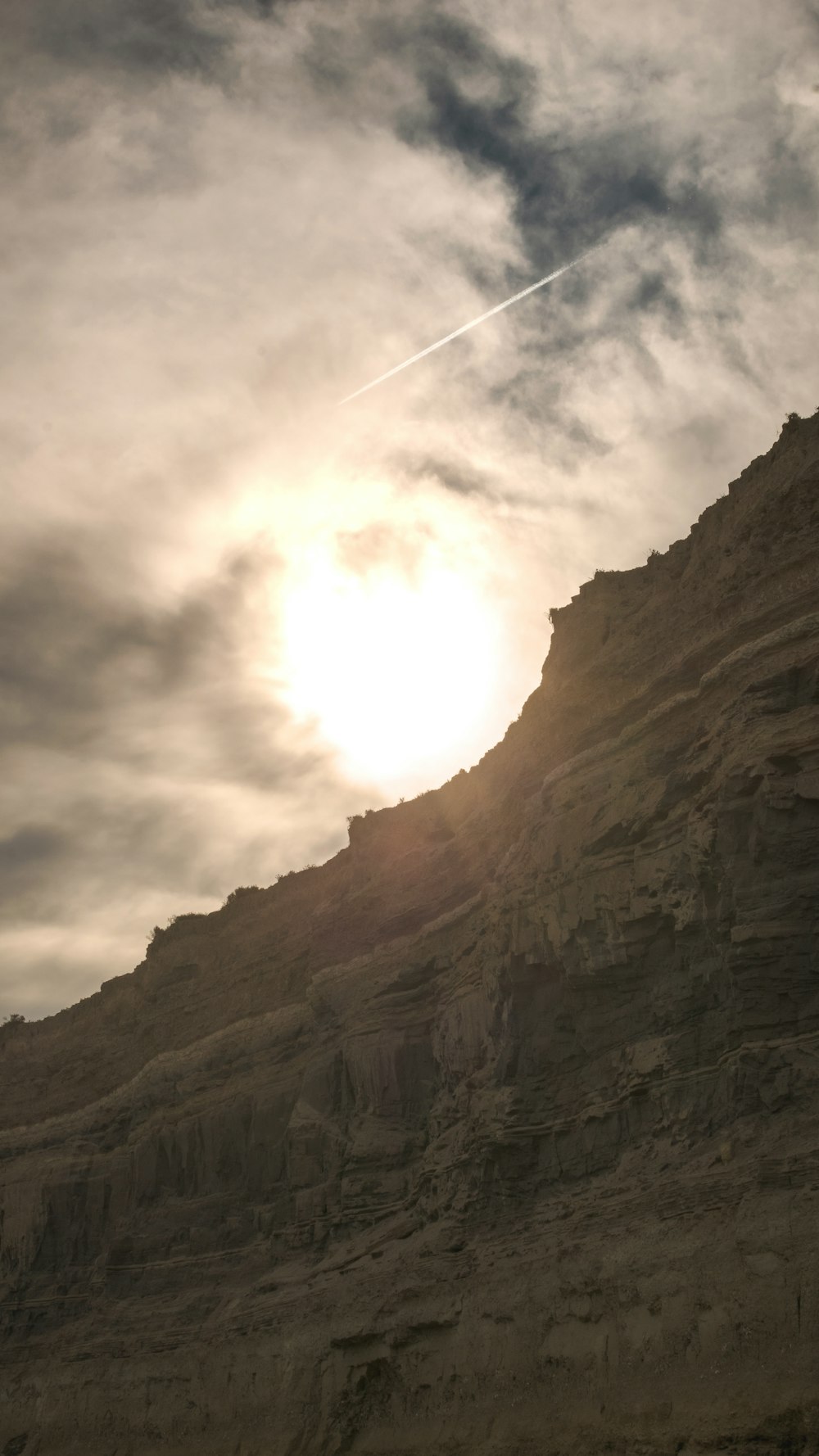 brown rocky mountain under white clouds during daytime