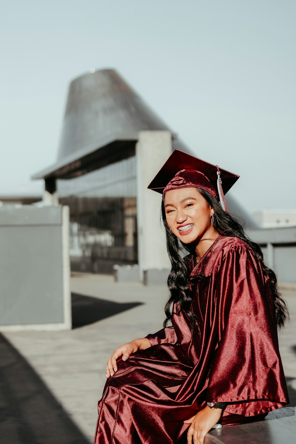 woman in red academic dress smiling