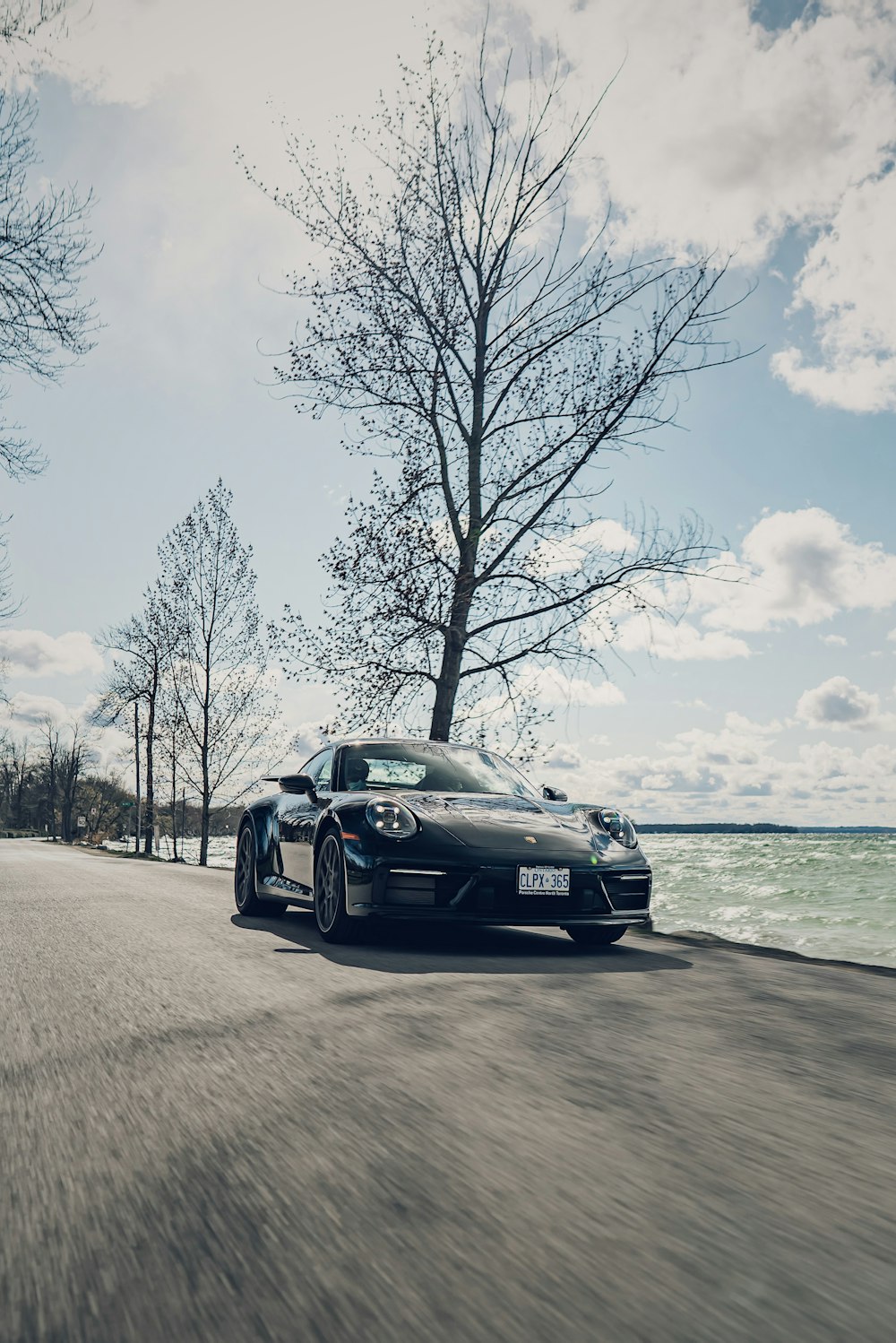 black porsche 911 on beach during daytime