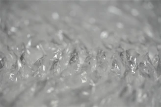 Close-up of padded envelopes and bubble wrap protecting delicate items.