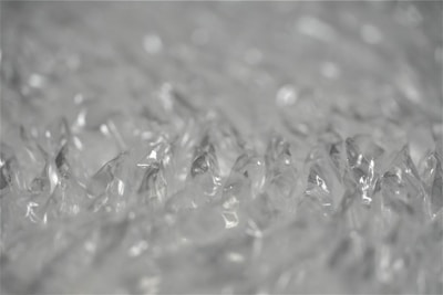 Close-up of bubble wrap cushioning a fragile item inside a shipping box.