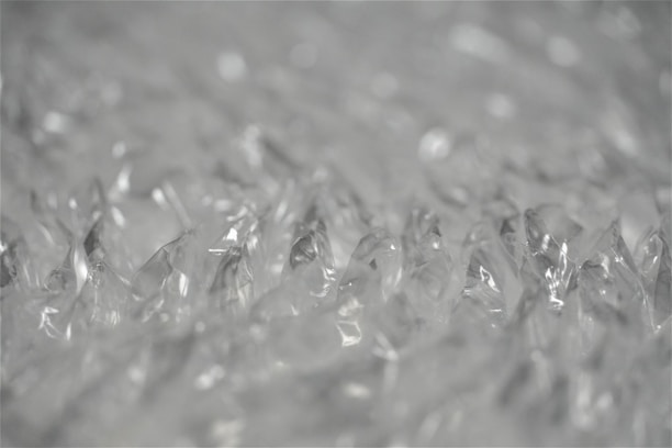 Close-up of bubble wrap cushioning a fragile item inside a shipping box.