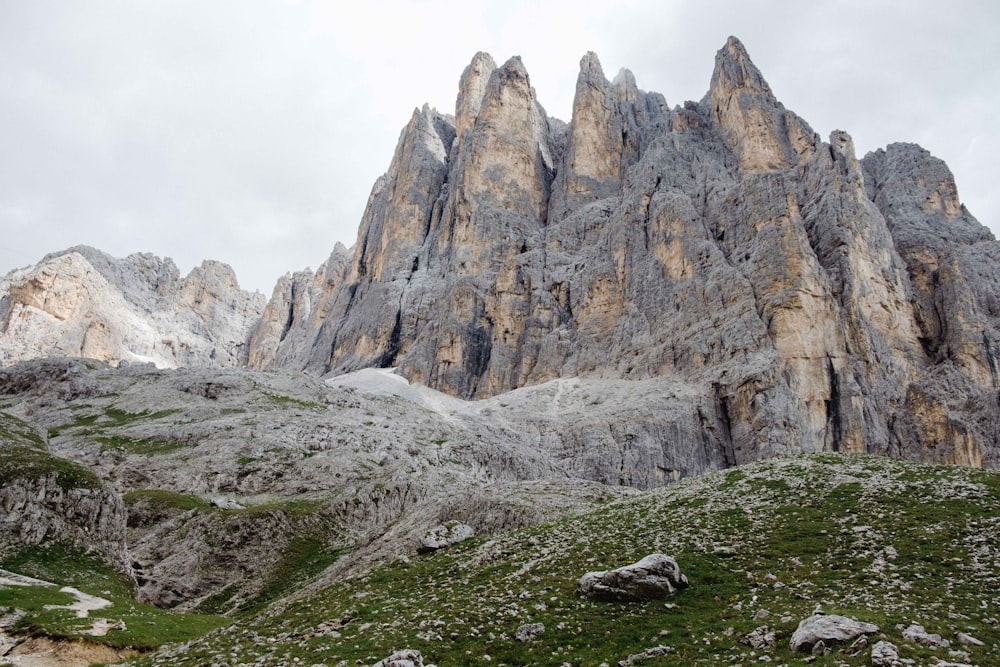 gray rock formation on green grass field during daytime