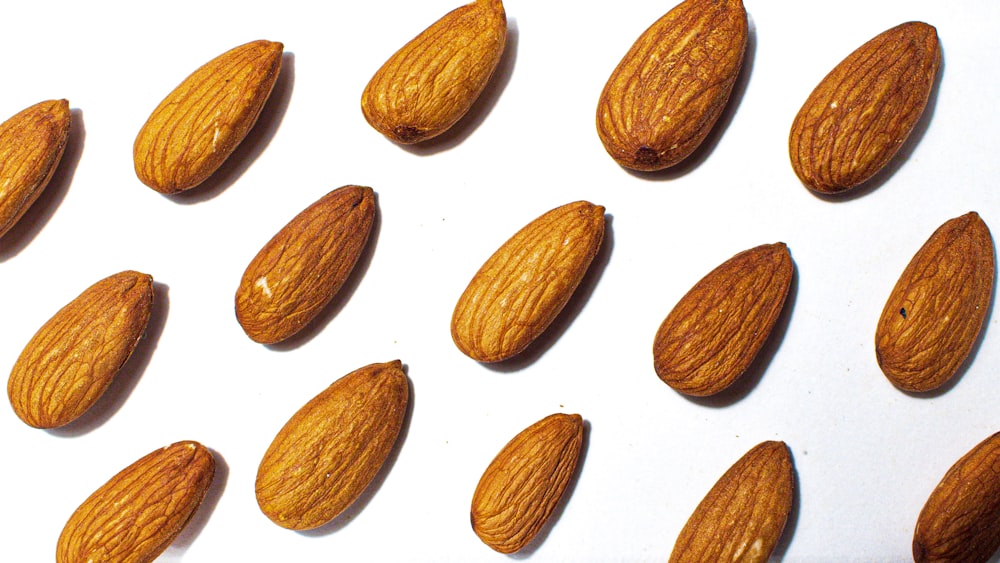 brown almond nuts on white background