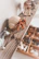 A cozy shelf displaying various handmade ceramic animal figures in warm lightcoral tones.
