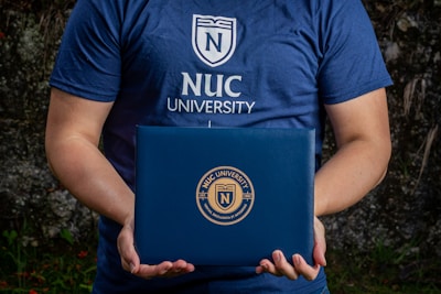 The BCCC logo embossed on a sleek, royal blue corporate folder with gold accents.