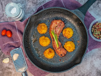 fried chicken on black frying pan