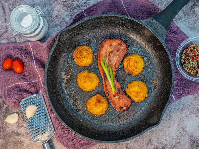 fried chicken on black frying pan