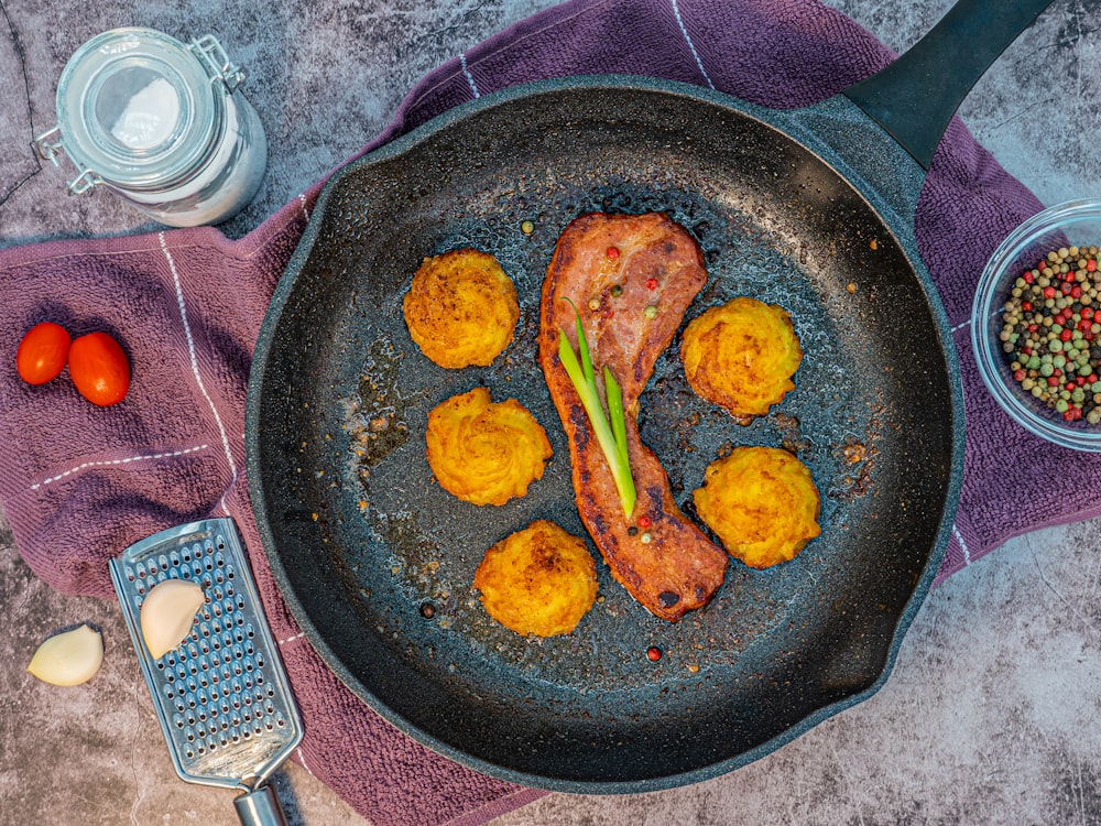 fried chicken on black frying pan