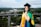 woman in academic dress and academic hat standing on green grass field during daytime